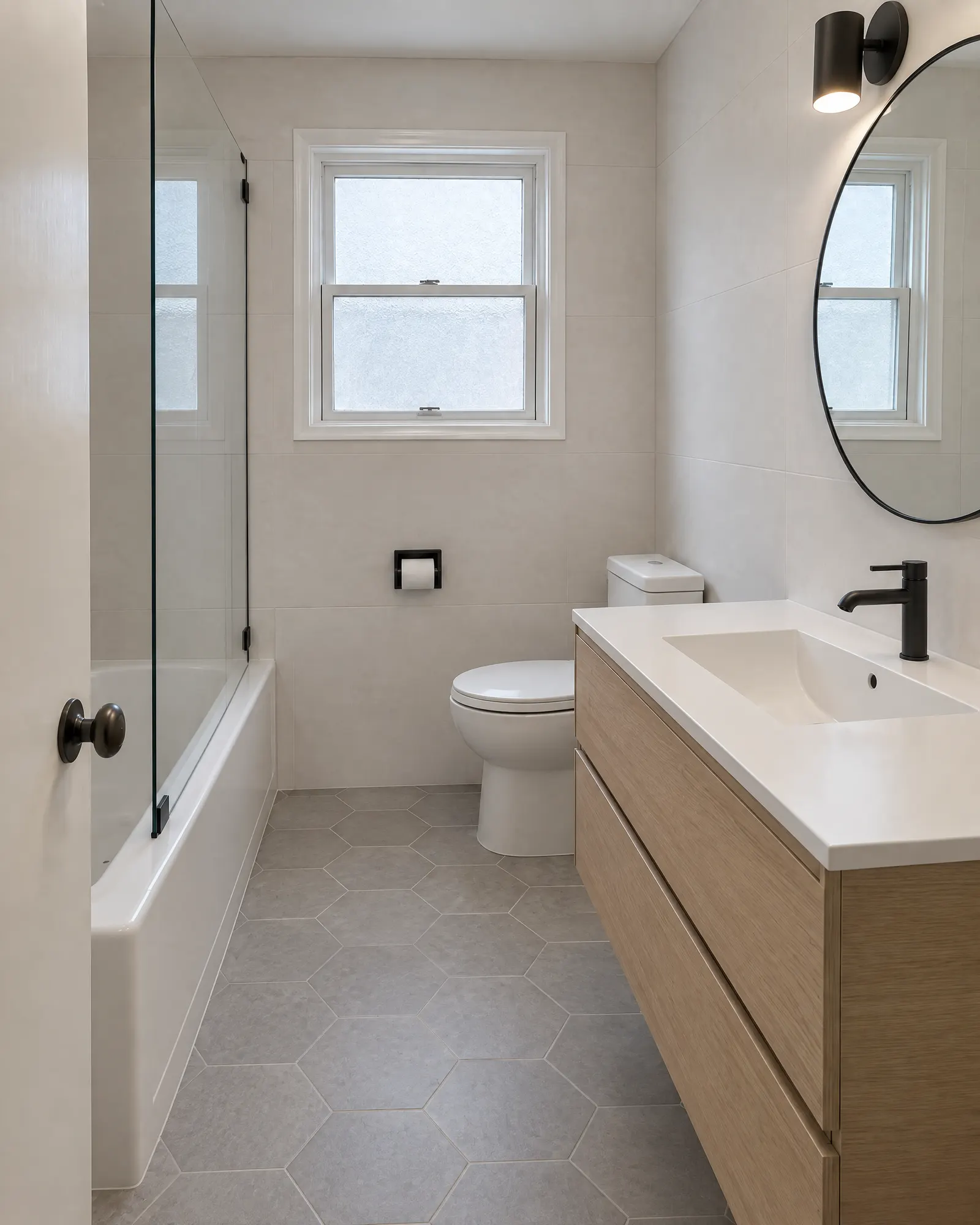 Small bathroom from the doorway, pink 1960s tile before and full renovation after (after)